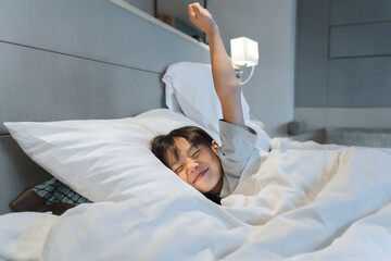sweet little child Girl sleeping on a bed with plain white sheets in a bedroom at home. Peaceful sleep. Sweet, peaceful dreams. Cute face close-up. child sleeps deeply Feel relaxed and comfortable.