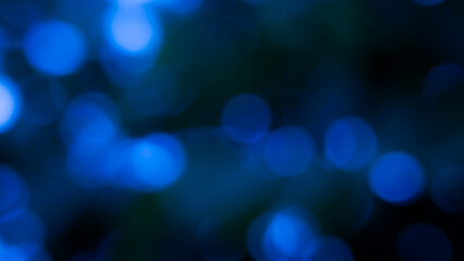Blurry background with out-of-focus circular light spots that create a dreamy and hazy effect. Dark...