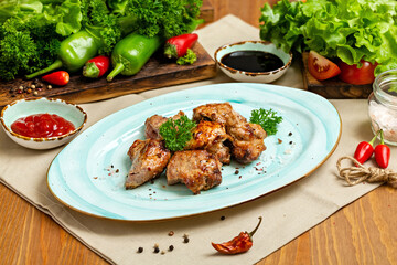 Grilled pork shashlik pieces on a plate. Restaurant, Cafe, lunch.
