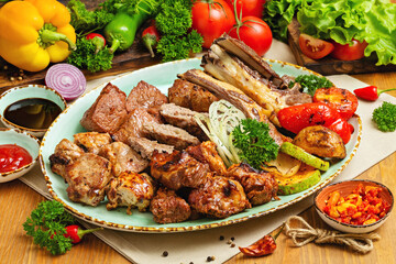 Meat platter, shashlik, kebab, chicken wings and grilled vegetables on a plate. Restaurant, Cafe, lunch, dinner.