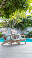 Obraz premium Relaxing outdoor lounge chairs beside a serene blue pool in a lush garden setting