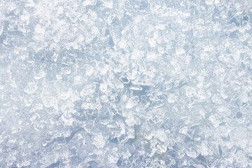 close-up of ice and frost in freezer tray with cold blue tones