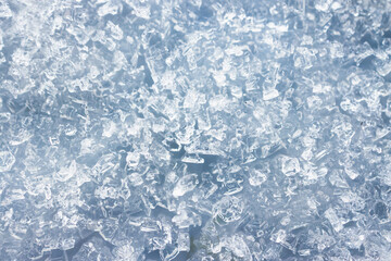 close-up of ice and frost in freezer tray with cold blue tones