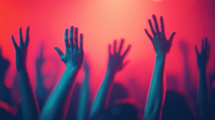 Close up of energetic hands raised in joyful dance surrounded by a vibrant crowd moving to the...