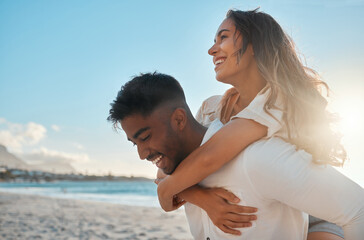 Piggyback, fun and couple by beach on holiday, getaway or vacation with travel together. Happy, love and interracial man and woman with playful romance by ocean or sea on date on weekend trip.