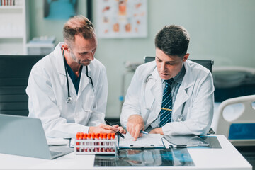 Fototapeta premium Group of medical practitioners working together and analyzing medical scan in the hospital