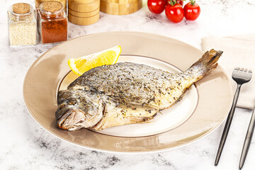 Baked Dorado fish served lemon