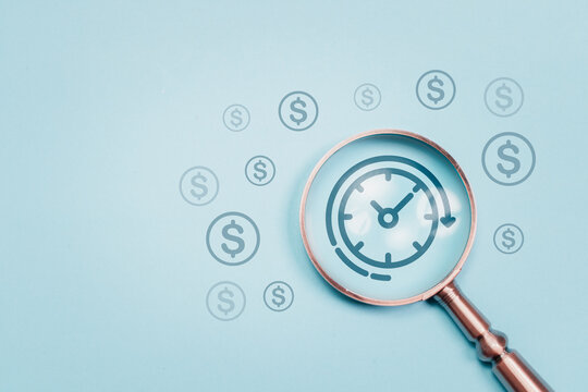 Time is money and time management concept, work planning increases efficiency and reduced work time. Magnifying glass focus to clock and money icon for business time management.