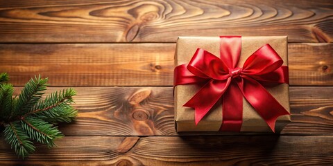 Fototapeta premium Christmas present wrapped with red bow on a decorated wooden table
