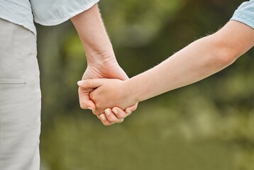 Parent, kid and holding hands with love in nature for bonding, safety or protection at park....