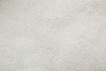 White cuddle teddy bear fabric as background, top view