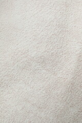 White cuddle teddy bear fabric as background, top view