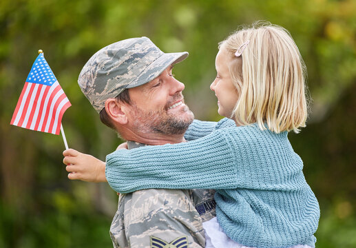 Army, flag or smile with father and daughter in garden of home together for return from war. Family, love or military with man parent and girl child outdoor in USA for bonding, safety or support