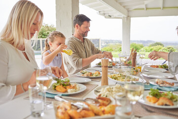 Family, lunch and people eating food with child at patio outdoor for thanksgiving celebration at home. Father, mom and kid with meal at gathering on festive holiday for nutrition, drink and health