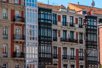 Typical facade of residential buildings with balconies and bay windows in downtown Bilbao,...