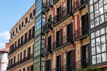 Typical facade of residential buildings with balconies and bay windows in downtown Bilbao, autonomous region of the basque country