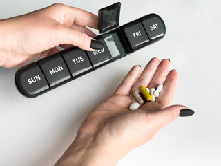 Weekly pill organizer and assorted supplements for daily health routine