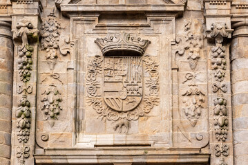 A coat of arms carved into the stone of the Southern facade of the famous cathedral Santiago de Compostela in Galicia