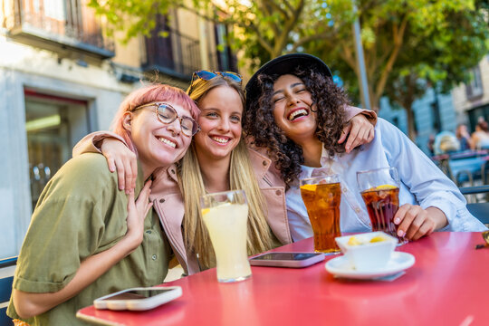 Happy friends meeting on a bar terrace