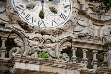 A face beneath a clock at the classicistic bell tower of the famous cathedral in Santiago de Compostela, Galicia