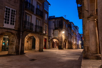 Empty little Rua do Vilar street with historic residential houses and picturesque passages in the center of Santiago de Compostela at night