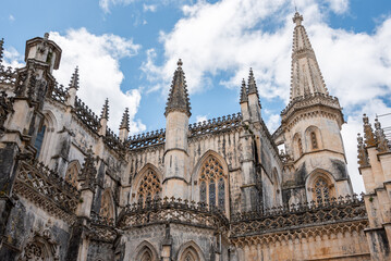Fototapeta premium Picturesque detail of medieval Santa Maria da Vitoria monastery church in Batalha, a manueline gothic masterpiece, view on the southern facade