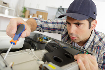 plumber with clipboard near washing machine