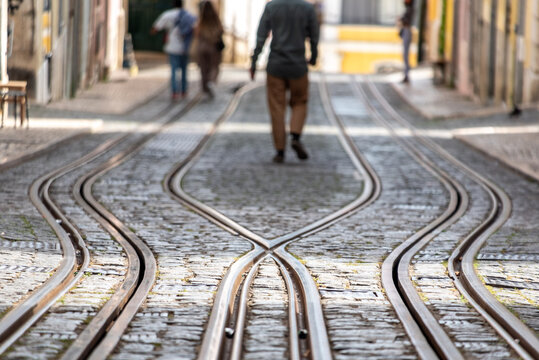 Tourists walking at the ascensor tracks at Bica de Duarte Belo street in old town Lisbon