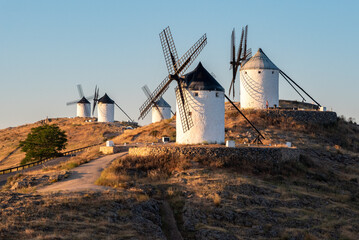 Iconic historic windmills in Consuegra at sunrise, Spain, known from Cervantes novel Don Quichotte