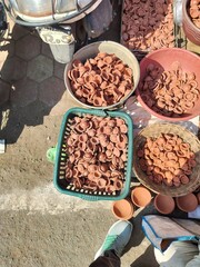 Diya's selling in the market for diwali occasion. People selling hand made diye (handmade candle or oil candle). Stock of dipawali diya's. Collection of diya or oil lamp. 