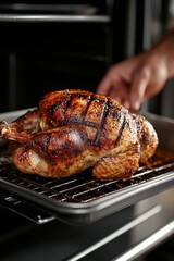 Fototapeta premium Delicious whole roasted chicken being taken out of the oven
