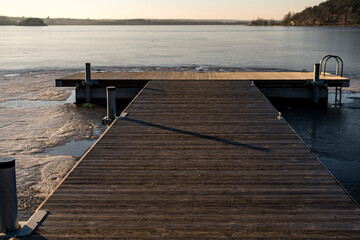 Small pier on a frozen lake in wintertime