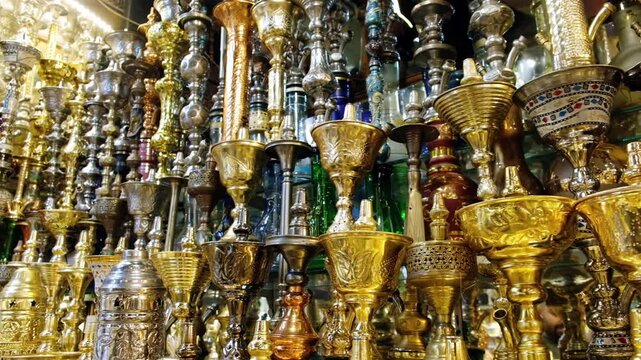 Shining shishas at souvenir shop. Rows of hookahs at market. Narghiles for sale at traditional middle eastern market. Khan El Khalili market, Cairo, Egypt