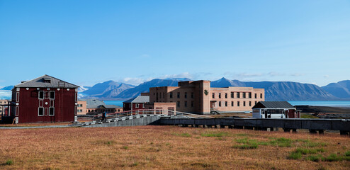 Exploring the abandoned buildings of Pyramiden in Svalbard on a bright sunny day