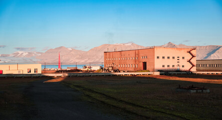 Exploring the abandoned buildings of Pyramiden in Svalbard during a sunny day