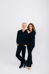 a guy and a girl in black suits on a white background