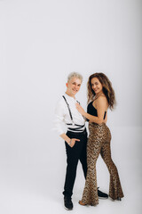 Cheerful Young Couple Crossing Hands In Confident Gesture Smiling To Camera Standing Back To Back Over White Studio Background. Happy Friendship And Love Relationship Concept