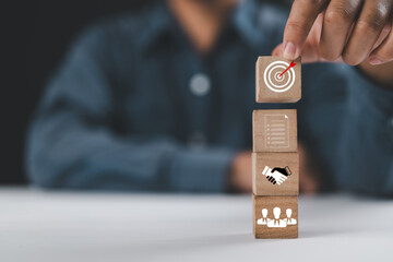 Business goal with growth success process for Leadership concept. wooden cube blocks as a stair step with target and strategy icons, vertical style. Concept success and business goal.