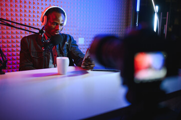 African american video blogger records content in his studio.