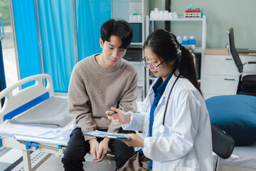 medicine, healthcare and people concept - doctor talking to male patient at bed in hospital.