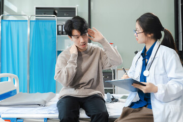 medicine, healthcare and people concept - doctor talking to male patient at bed in hospital.