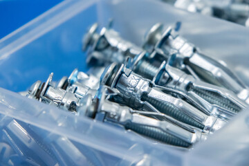 Metal dowel fasteners laying in organizer box