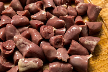 Fresh chicken hearts arranged on a board. Perfect for concepts of raw meat, cooking preparation, and healthy protein sources.