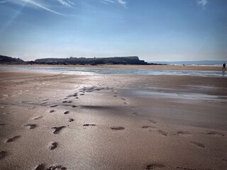 beach at dusk, footprints in sand