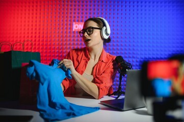 Young creative woman live streaming a video for her followers on social media