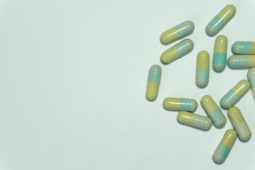 Many yellow and blue pills isolated on White Background