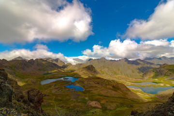 Fototapeta premium Landscape of the lakes on mountain tops and partly cloudy sky in the summer