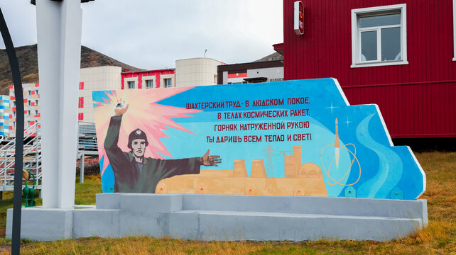 Barentsburg, Svalbard and Jan Mayen Islands - September 20, 2024: Mural depicting a worker celebrating technology and energy in Barentsburg, Svalbard