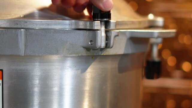 Canning potatoes for food storage. Using a pressure cooker method of canning potatoes after cleaning, chopping and dicing them and putting in mason jars for the winter food supply. Using a colander.