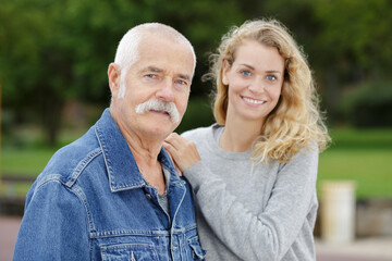 father and daughter in a sunny park